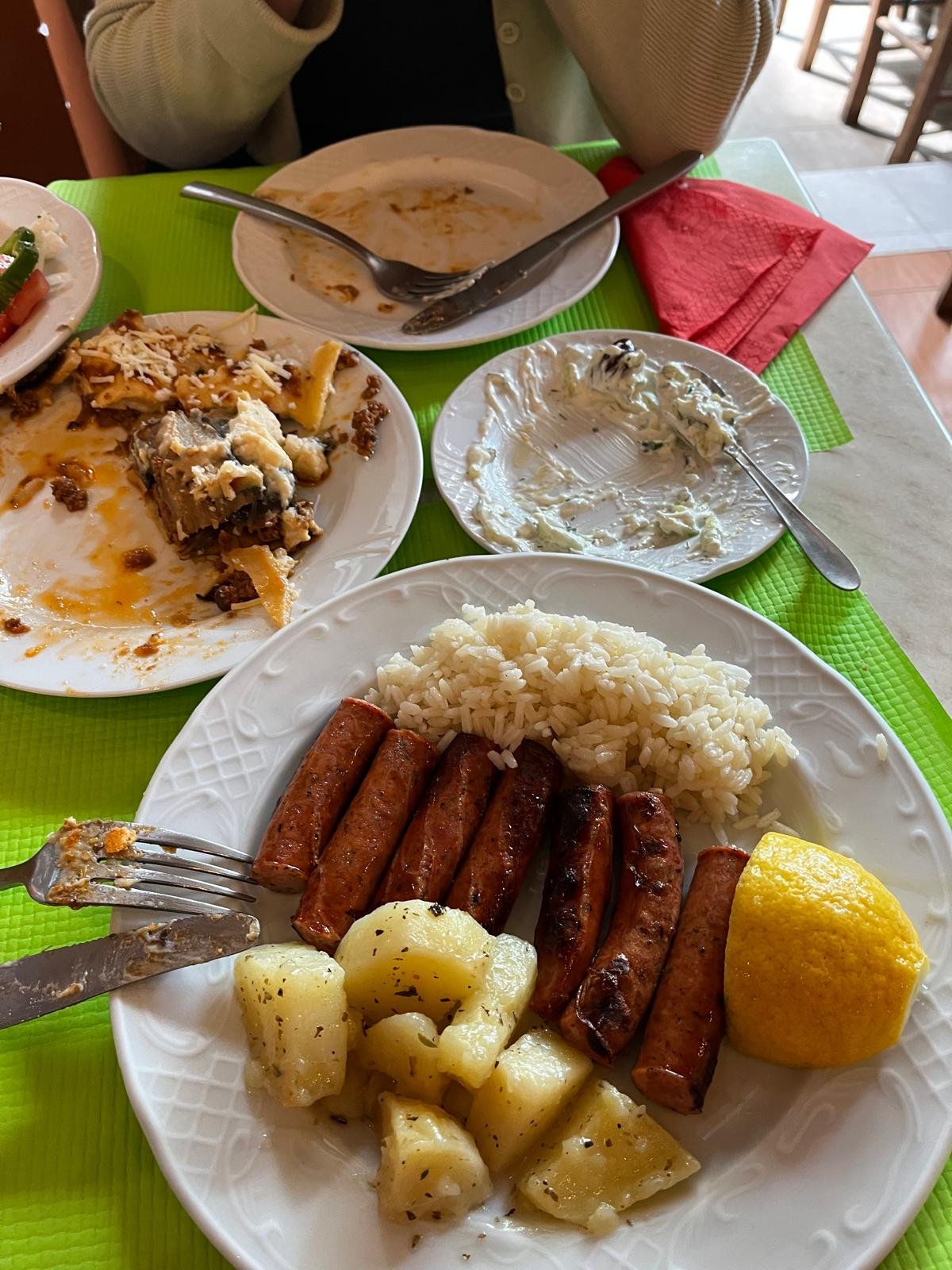 A traditional Athenian meal at a local restaurant away from the tourist areas — loukaniko sausages, rice, roasted potatoes