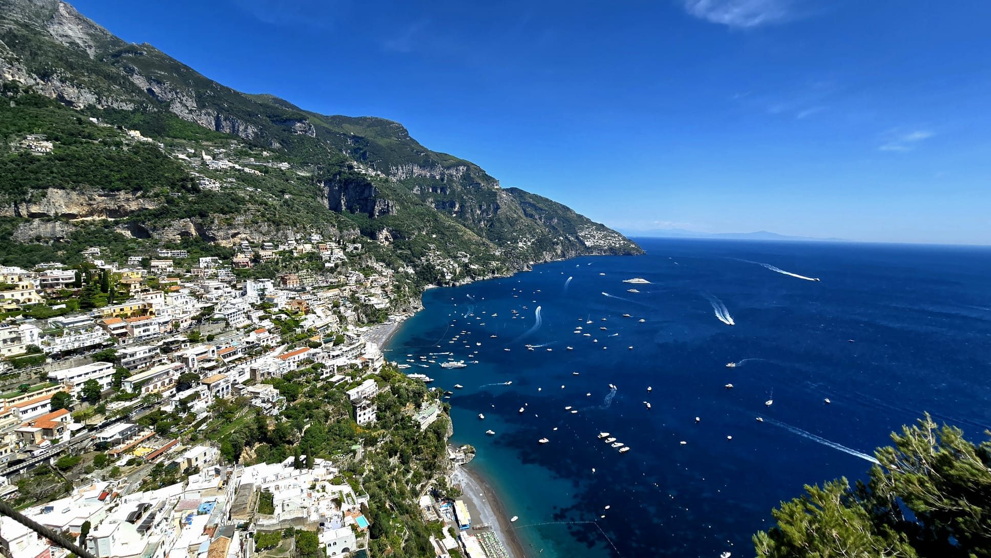 Positano on the Amalfi Coast — pastel houses cascading down the cliffside to a small beach and the deep blue sea