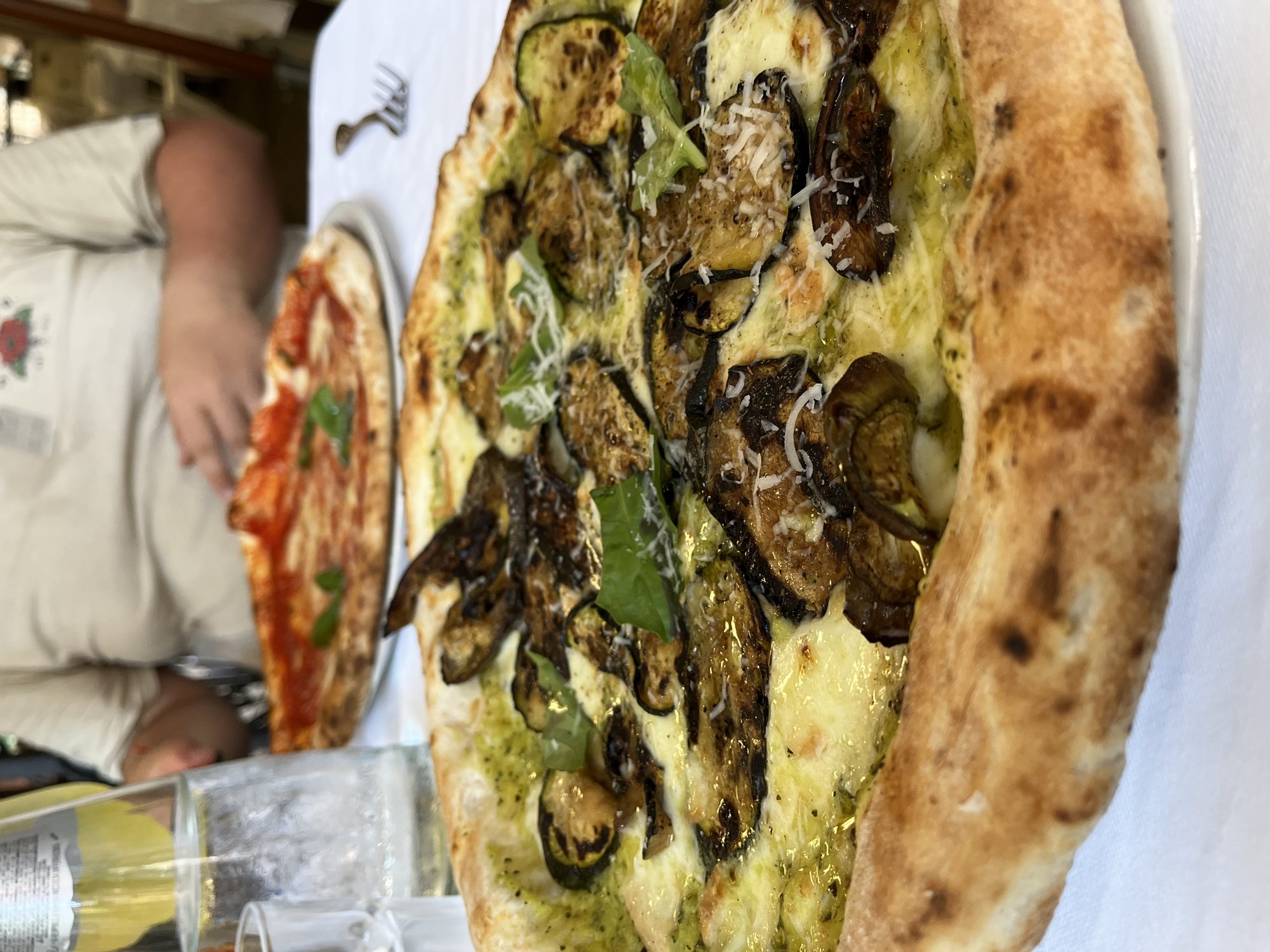 A close-up of a Neapolitan mushroom pizza at Antica Pizzeria Port'Alba in Naples — leoparded crust, melted fior di latte mozzarella and basil