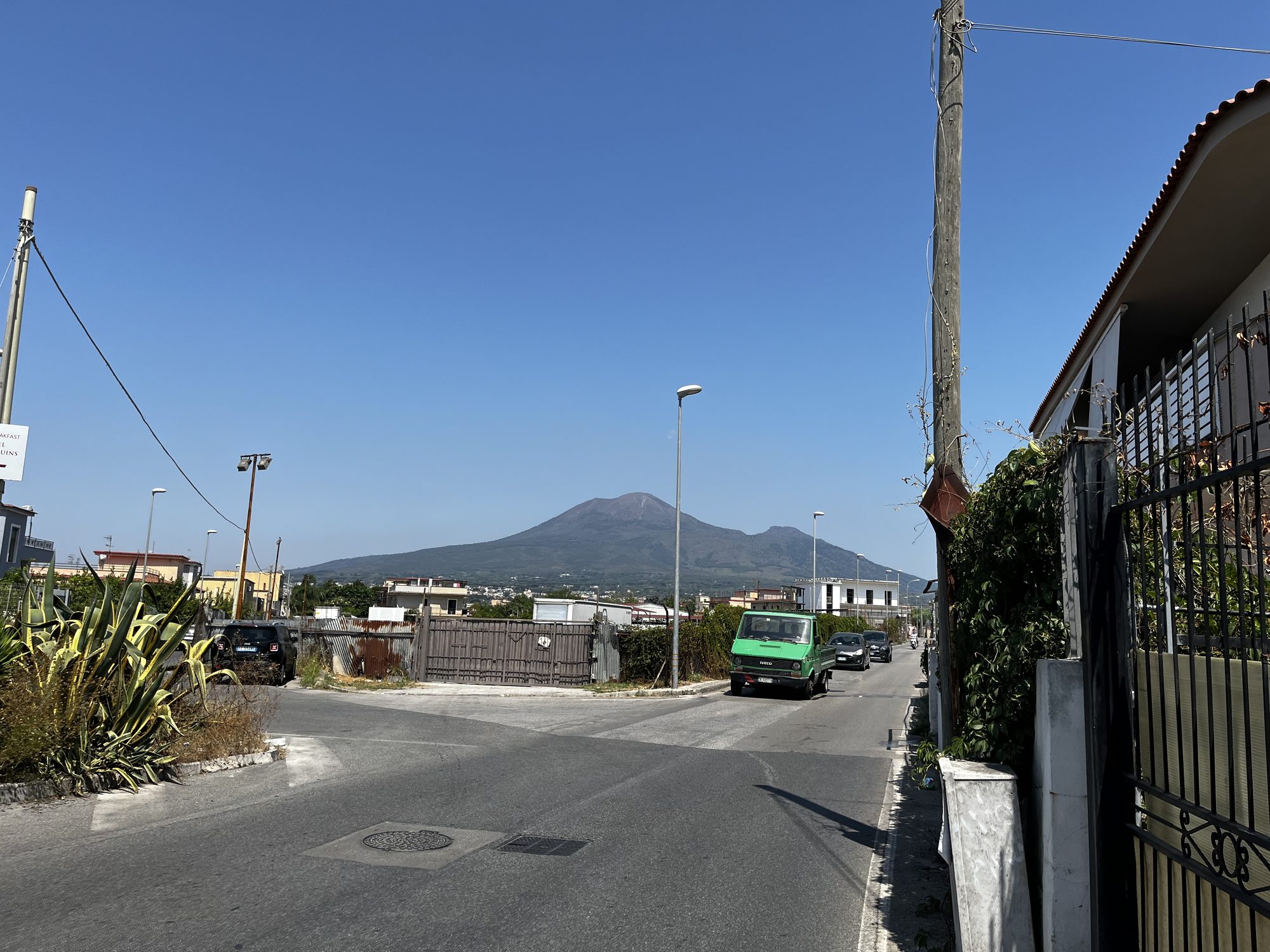 Mount Vesuvius rising above the streets of Torre Annunziata — the view from the walk to Pompeii