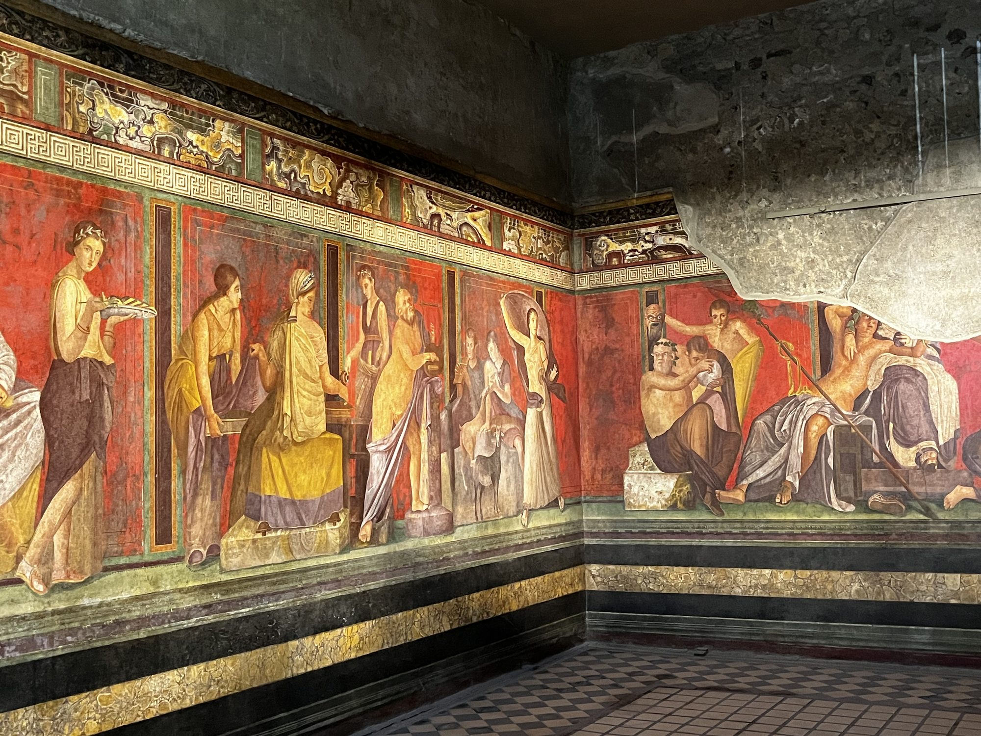 The famous Villa of the Mysteries frescoes at Pompeii — the continuous red wall painting depicting Dionysian ritual scenes, extraordinarily preserved