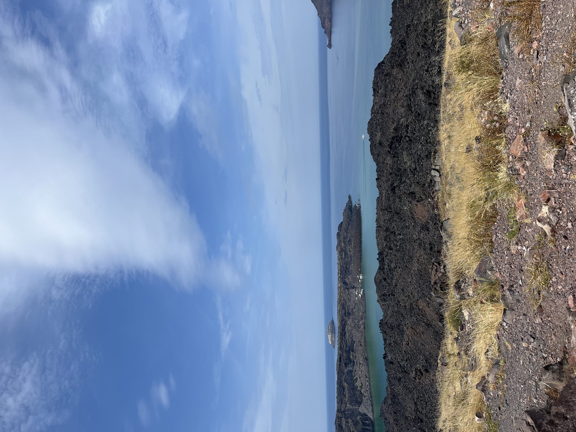 Nea Kameni — the active volcanic island in the Santorini caldera, black lava meeting turquoise water