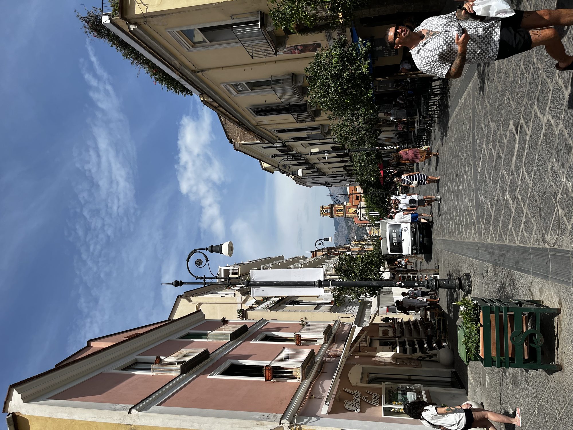 Corso Italia — Sorrento's main pedestrian street on a sunny afternoon, bell tower in the background