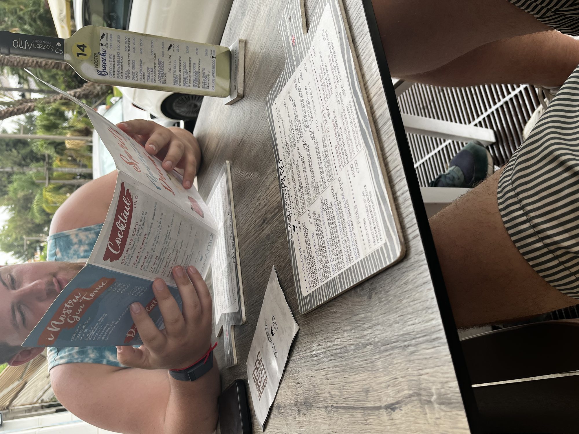 Yaron at Spizzichiamo restaurant in Sorrento, reading the cocktail menu
